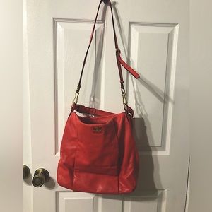 Coach Purse. Coral colored with gold embellishments.